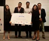 Snehal and four teammates holding large certificate indicating they won the case challenge.