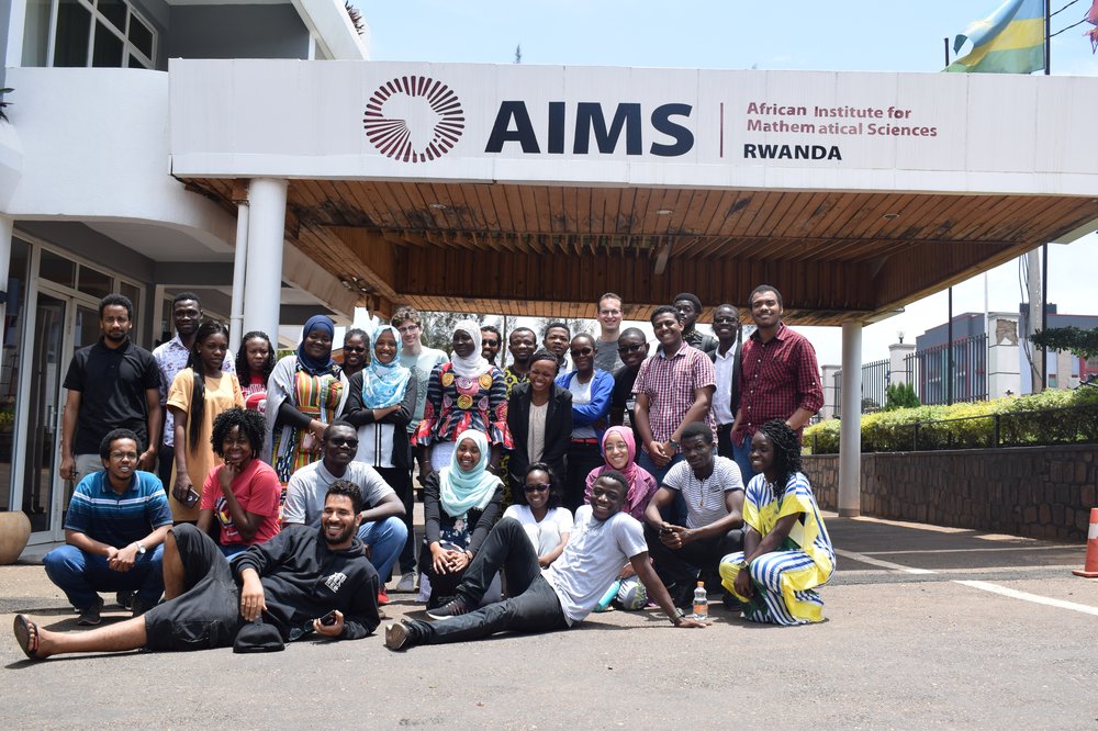 A picture of Abigail and lots of people outside the entrance to The African Institute for Mathematical Sciences