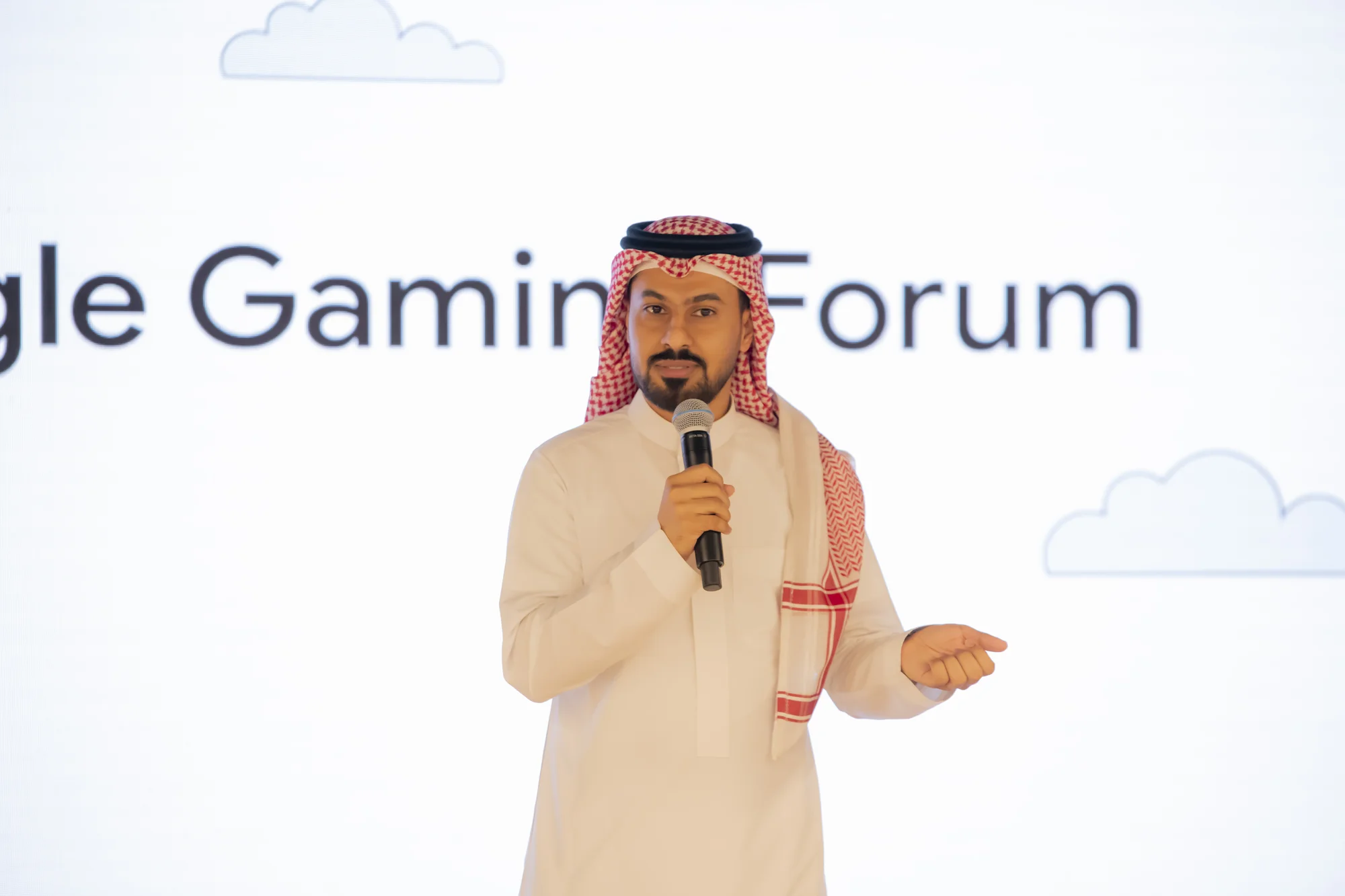 A photo of Abdullah Alshamrani, General Manager of CODE Centers, wearing a ghutra and shumakh presenting a keynote at the Google Gaming Forum on 13 June