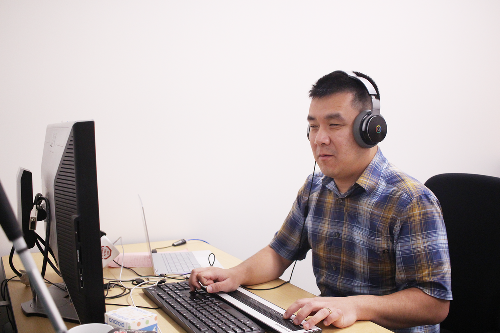 David using ChromeVox on his Chromebook at work