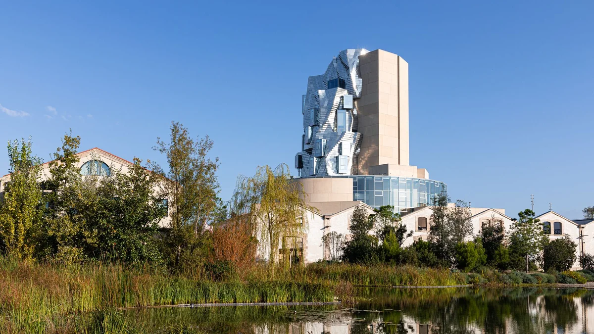 image of luma tower beyond a pool of water