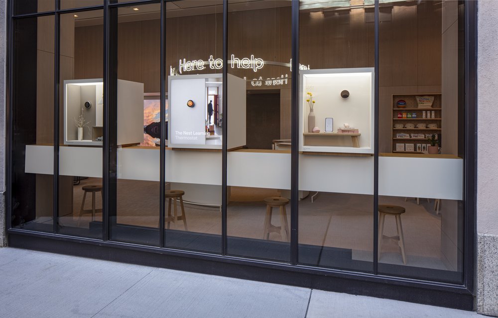 Three Discovery Boxes containing Google hardware products line the store windows.