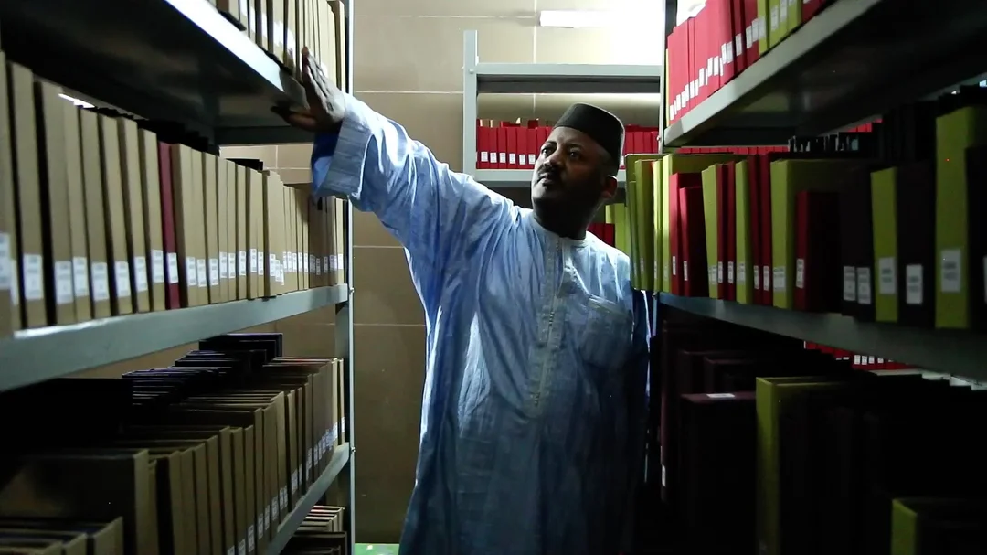 Dr. Haidara in the stacks at the library containing the preserved manuscripts