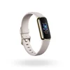 The Fitbit Luxe with a white band, floating in front of a white background. The display features the time and heart rate.