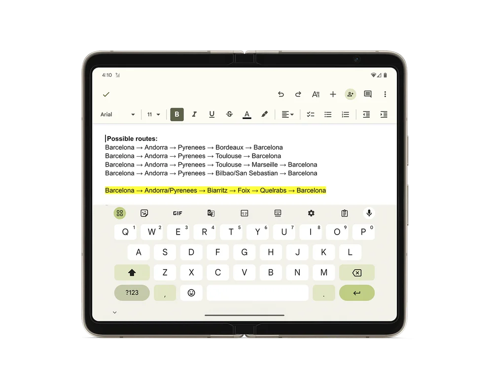 A rendering of a Pixel Fold opened completely showing a Google doc with trip planning notes. The app is opened across both screens and there’s a digital keyboard open on the bottom half of the screen.