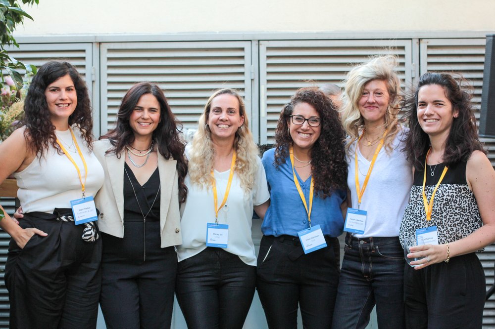 Six women founders stand side by side, smiling at the camera.
