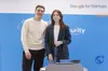 From L-R the male founder Andriy Kusyy and female founder Ksenia Iliuk of startup LetsData behind a podium with the Google for Startups signage in the background.