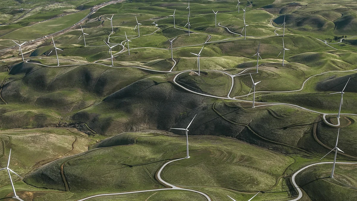 Photo of hillside with windmills