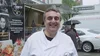 A picture of Andrea Li Puma, the owner of the food truck Pastammore based in Bucharest, in a white coat in front of his truck