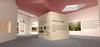 Interior of a virtual reality gallery space with a central pillar, with various poems and artworks visible on the walls