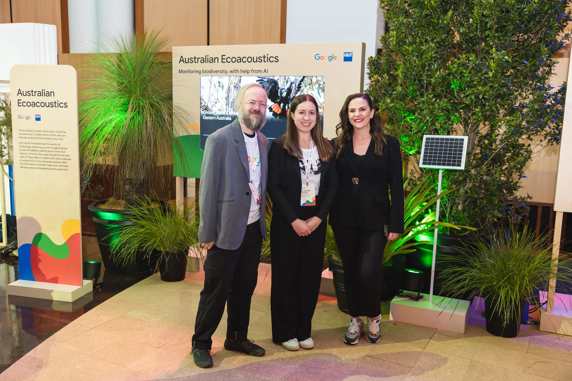 Tom Denton, Software Engineer, Google with Dr Daniella Teixeira, Research Fellow from QUT and Google Australia MD Mel Silva in front of an exhibit showcasing a new ecoacoustics partnership with QUT.