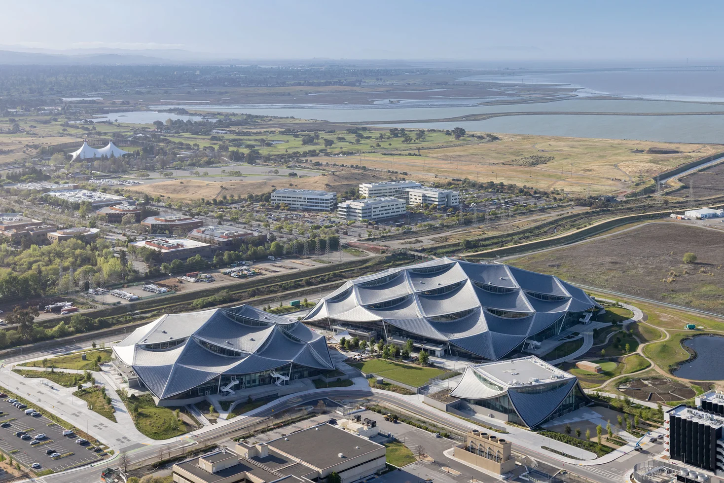 A helicopter aerial image shows the Bay View development and baylands.