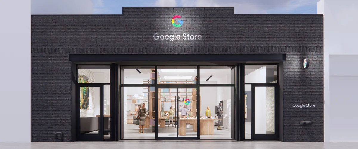 Illustration of a black one-story building with large windows. Inside are people walking around wooden tables and white walls containing Google hardware products. There is a Google Store logo on top of the building.