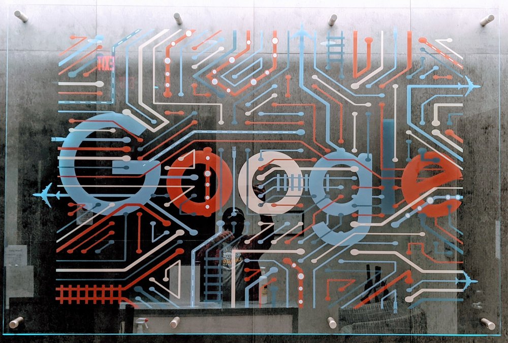 Red, white and blue airplane-themed Google logo sign at a Google data center.