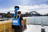 Photo of the the back of the Street View trekker backpack on the top deck of the ferrry, with a view of Sydney Harbour and the Harbour Bridge