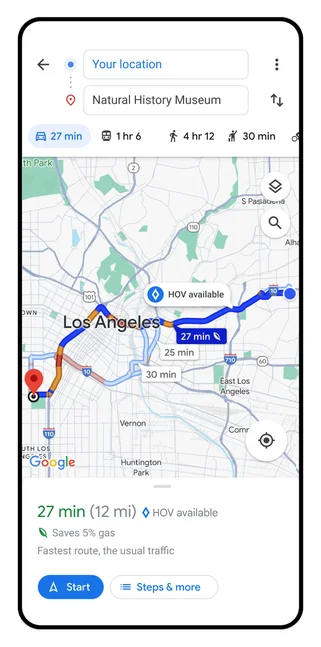 A still image shows a phone screen with a highlighted route overview of Google Maps directions to the natural history museum. A small, white notification indicates where an HOV lane is available along the route.