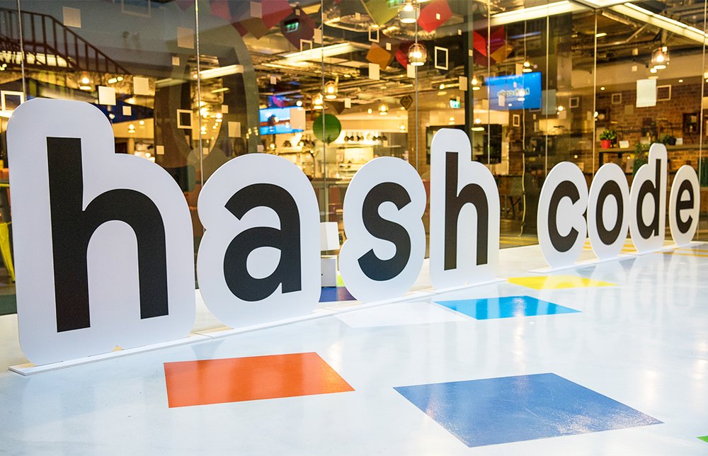 Photo showing cut out letters in a hallway that say "hash code."