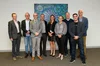 A photo of the partners standing together in front of a blue patterned artwork. This includes Prof Greg Leigh AO (NextSense), Dr Simon Carlile (Google Research), Prof David McAlpine (Macquarie University), Dr Zachary Smith (Cochlear), Prof Catherine McMahon (Macquarie University), Dr Aleisha Davis (Shepherd Centre), Dr Malcolm Slaney (Google Research), Sam Sepah (Google Research), Dr Brent Edwards (National Acoustic Laboratories)