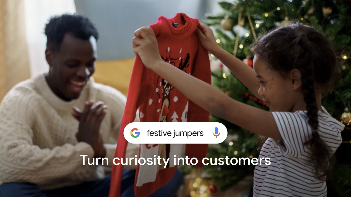 An adult and a child are opening gifts near a Christmas tree. '"Festive Jumpers" turn curiosity into customers' is on the image.