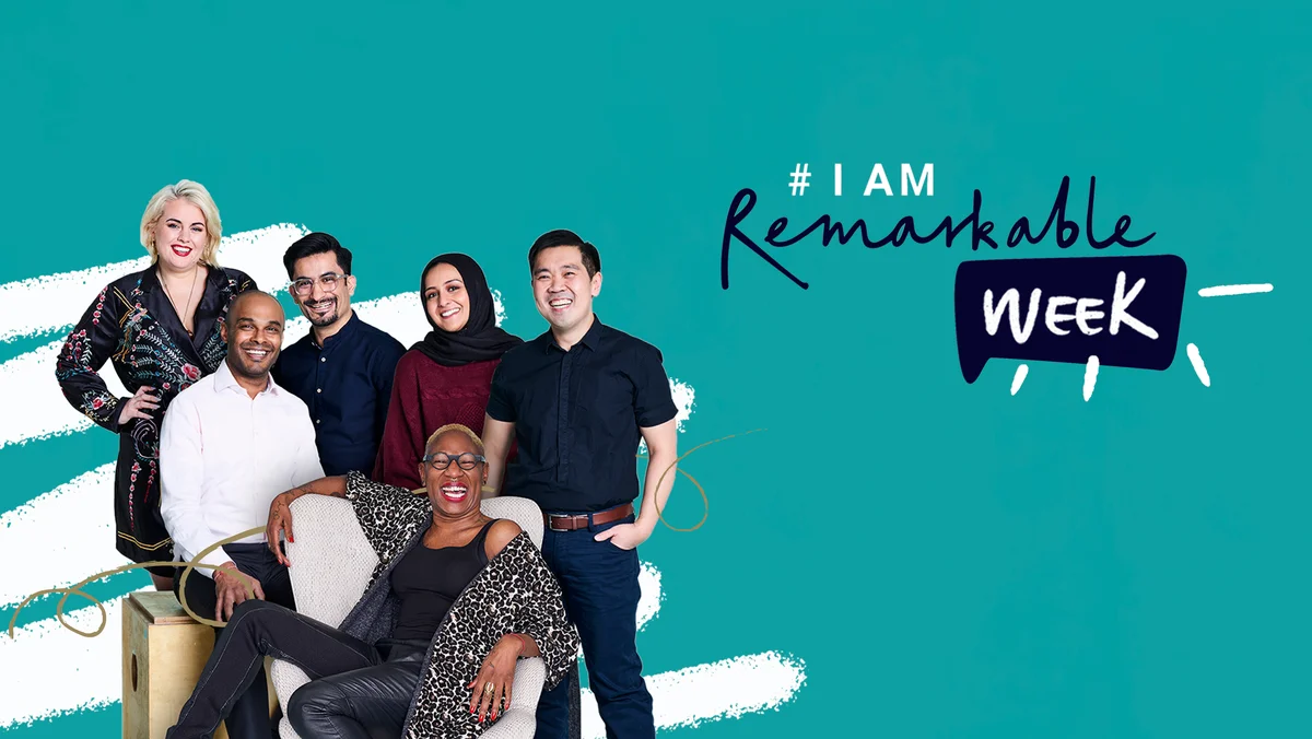 Six people standing or sitting and smiling next to the logo for #IamRemarkable Week