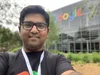 Selfie of Saad in front of a building with a Google logo on it.
