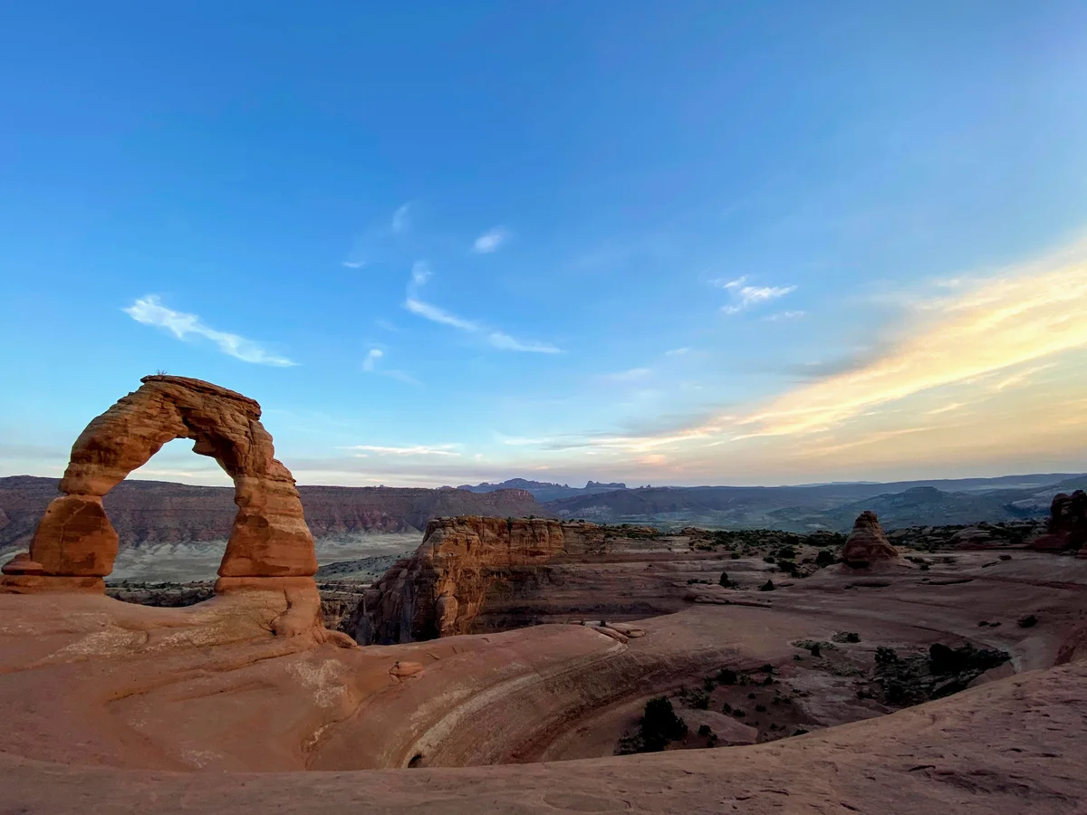 Delicate Arch rock formation at sunset.