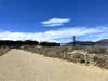 A photo of the Marina running trail in San Francisco. The sky is blue with some clouds and the Golden Gate Bridge is in the background.