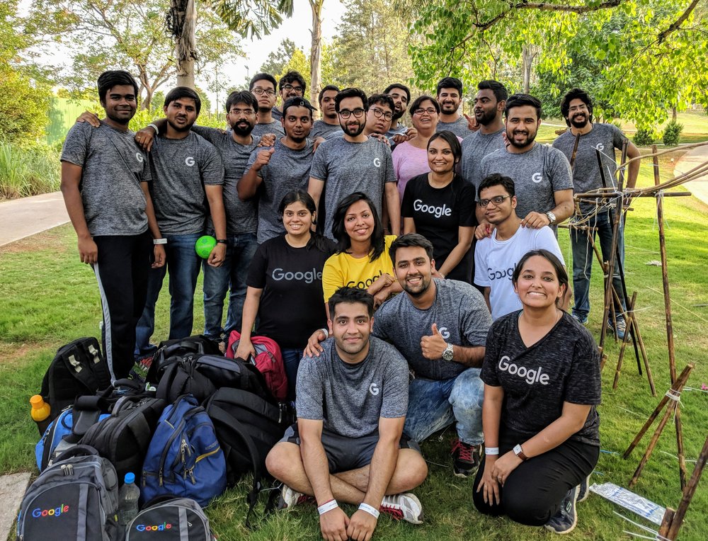 Nikhil with a group of interns outdoors.