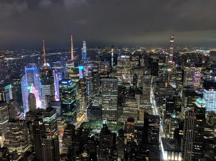 Image shows a city landscape at night.