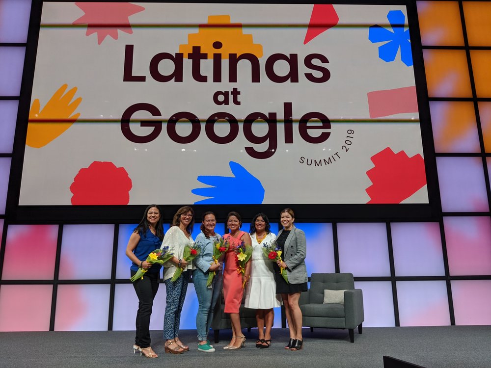 Monica and five others on stage under a “Latinas at Google” sign.