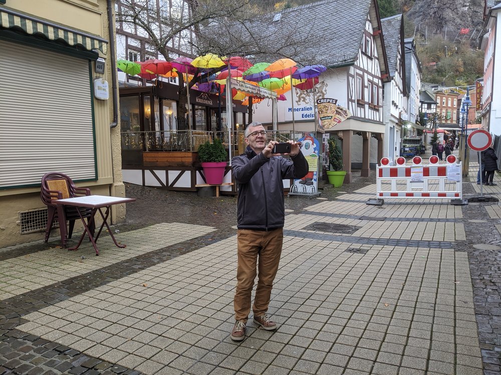 Jan taking a photo on a city street