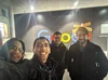 Yosri and three other new Googlers stand in front of a Google sign.