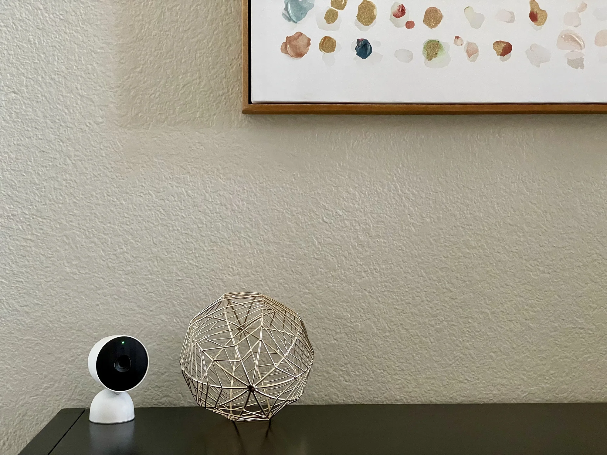 Nest Cam in the entryway beneath a framed piece of art.