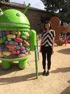 Jasmine standing next to an android statue filled with jellybeans.