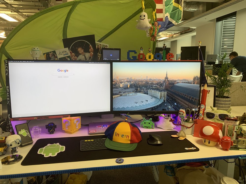 Ben’s desk at the London office includes two monitors, a Noogler hat and an Android sticker, as well as a collection of figurines and other decorations.