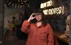 Jennifer, wearing glasses and standing in a Google office. A neon sign behind her says "show me your moves"