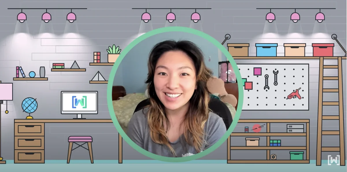 A photo of Julia, wearing a gray t-shirt and smiling at the camera, is in a green outlined circle in the center of an illustrated image. In the background is a workstation with desks, shelves and tools.