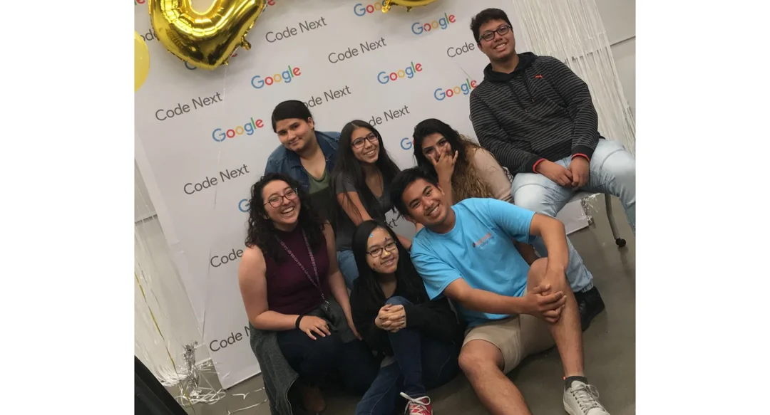 Lita Hernandez and 6 other Code Next students in front of a Code Next photobooth wall