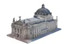 A screenshot of a 3D model of a theatre house. The building is lengthy in structure and is populated with high, ornate windows. Its entrance has three winged, bronze statues on top, highest in centre. And a large dark dome at the other end of the building.