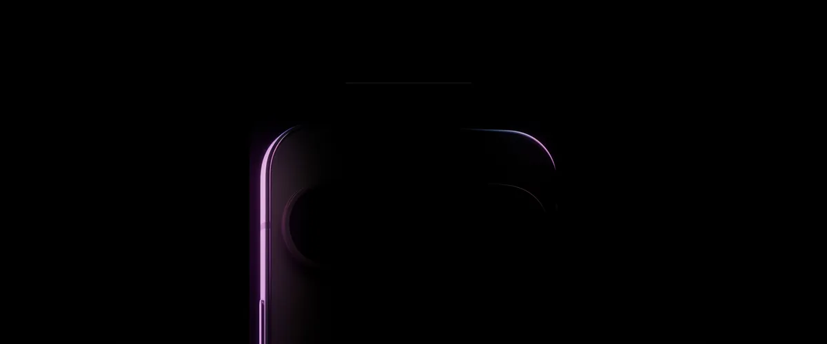 A black background revealing a slight outline of what appears to be the top of a phone. The corners are curved and silhouette — highlighted in a slight purple hue — fades to black. There is a pill-shaped outline on the top of the phone, the camera bar.