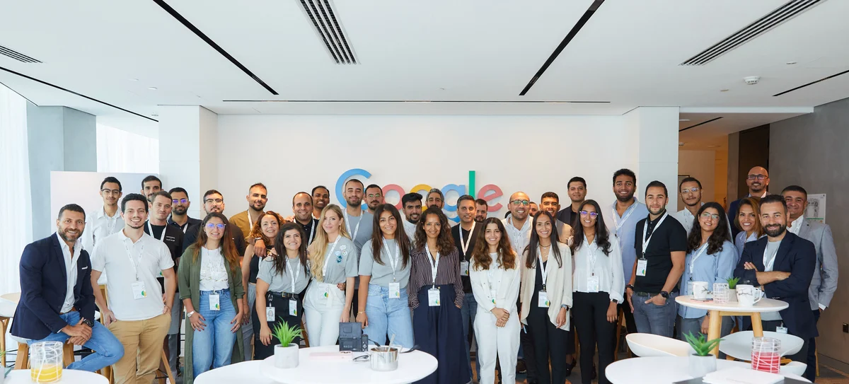 A group picture of tens of employees and startups at Google's office