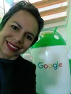 Monica smiling in front of a large Android statue.