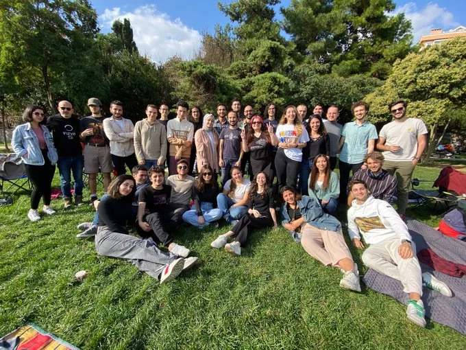 Large group of people outdoors looking at the camera.