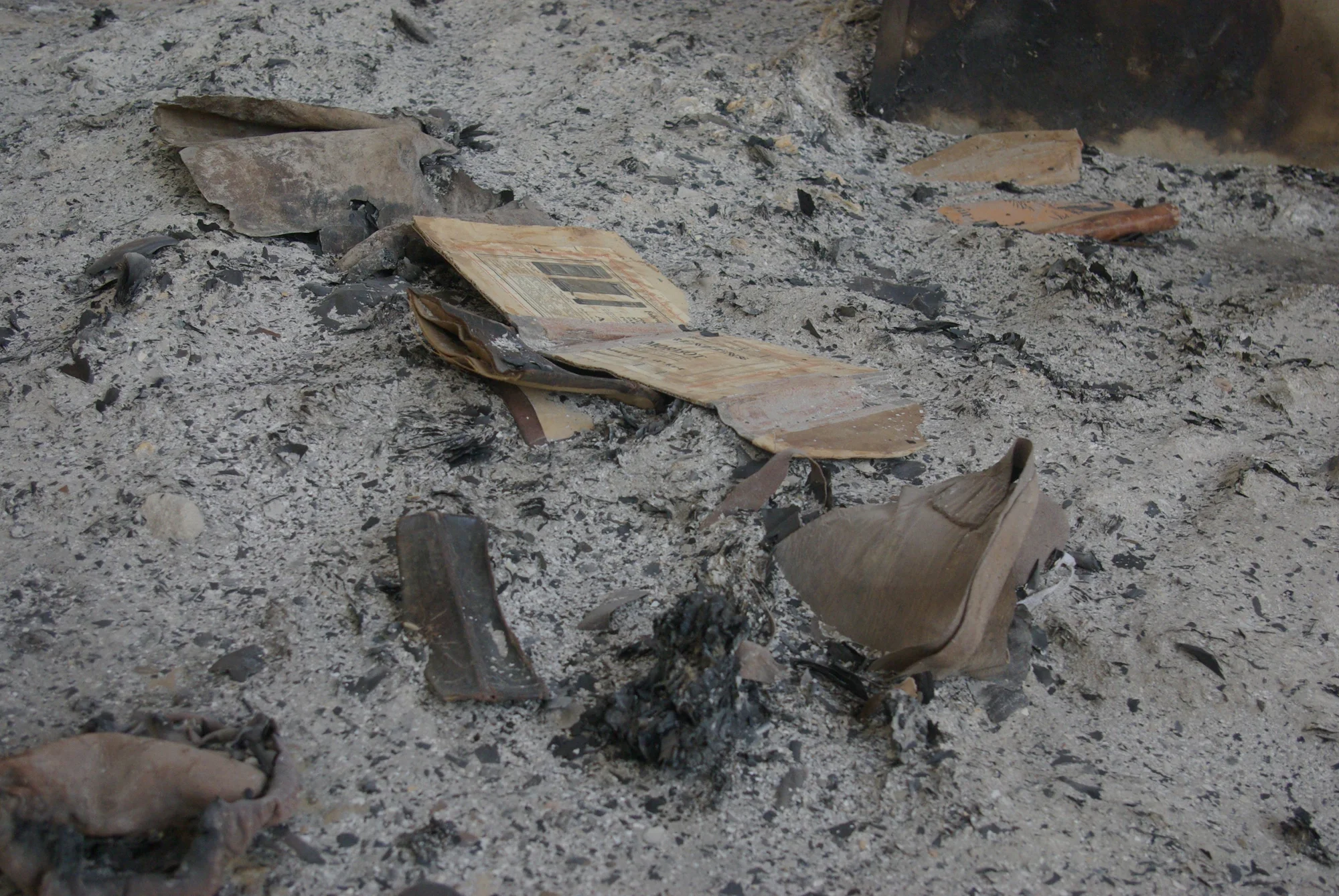 A damaged manuscript lies amidst debris resulting from the damage caused by the extremist occupation of Mali.