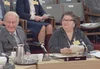 Mary Two-Axe Earley sits next to former Premier Rene Levesque at a desk with microphones on it.