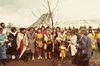 Photo showing a group of women gathered around a tree at a planting ceremony.