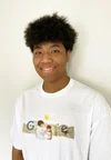 Photo of a young man looking into the camera and smiling.