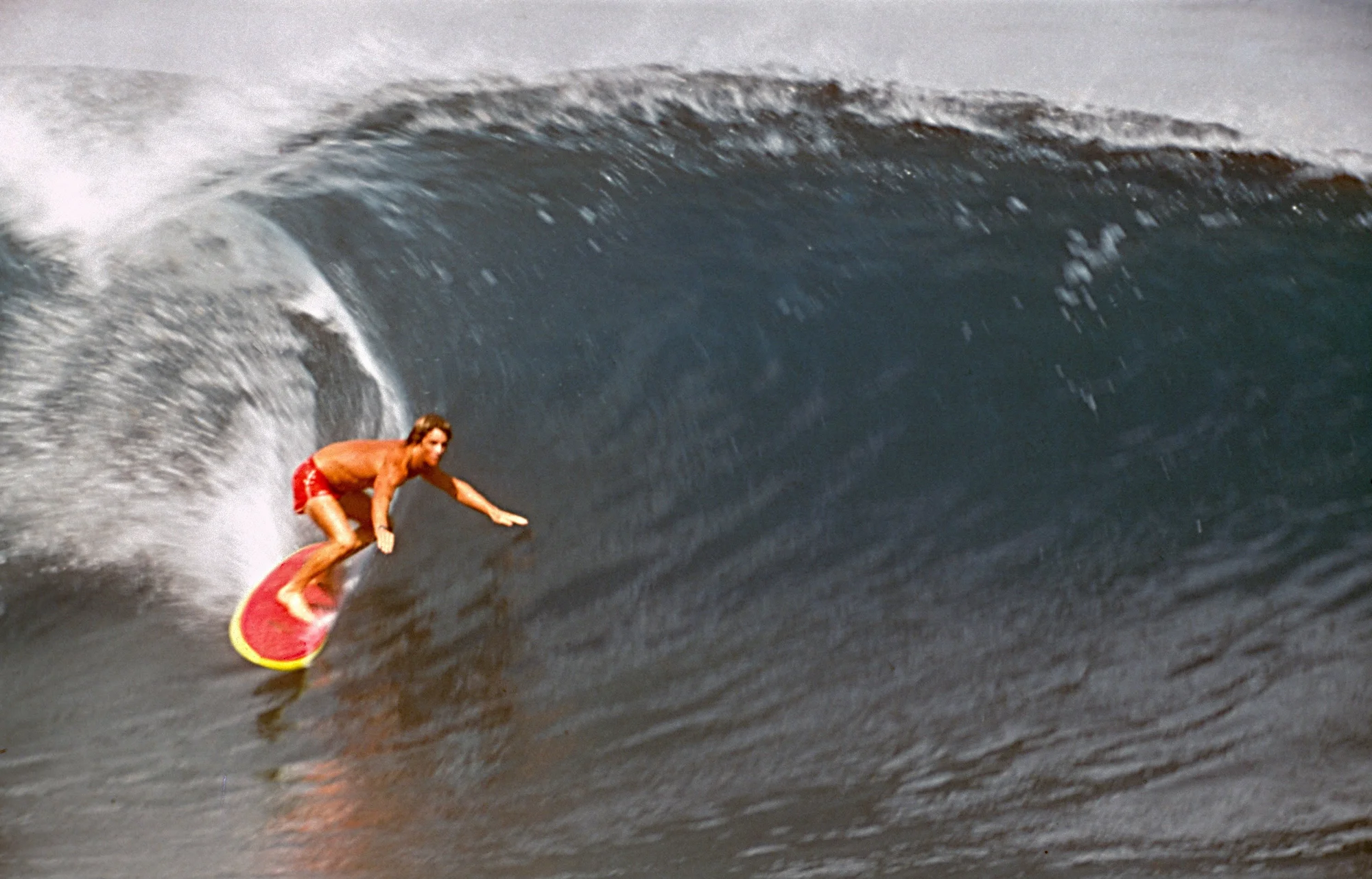 A surfer catches a wave