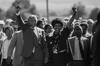 Nelson Mandela walks out of the gates of Victor Verster prison, 11 February 1990, photograph by Gideon Mendel / Courtesy of ARTCO Gallery, from the collection of the Nelson Mandela Foundation