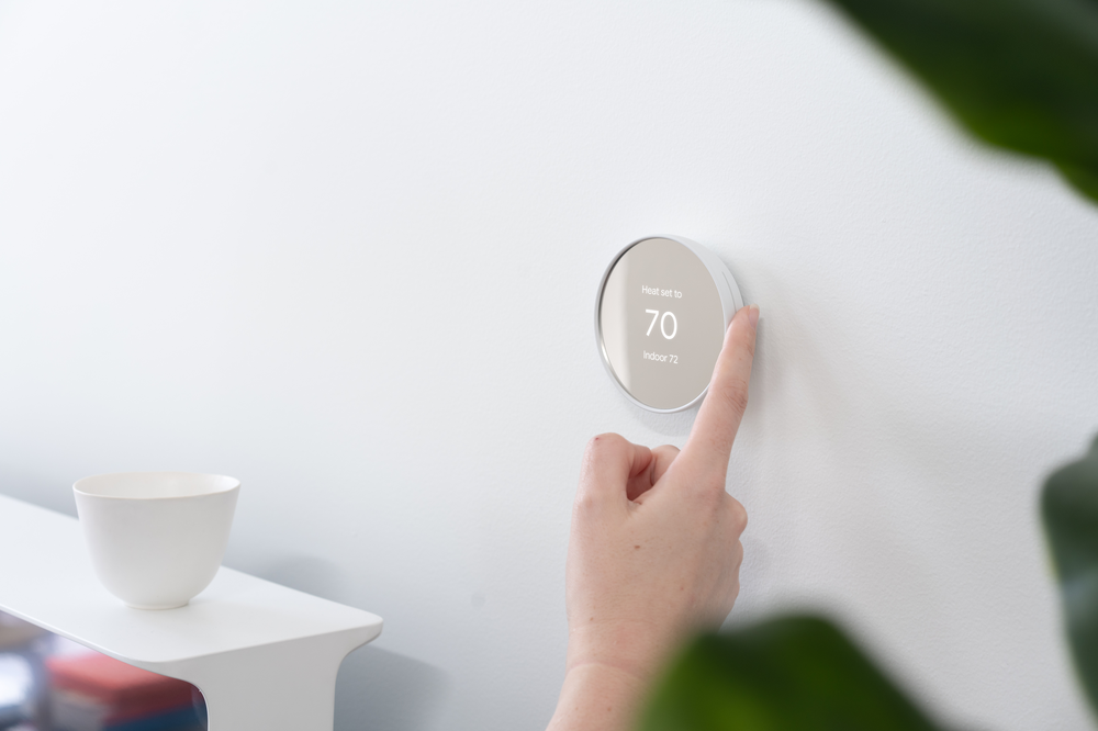 Person using Nest Thermostat